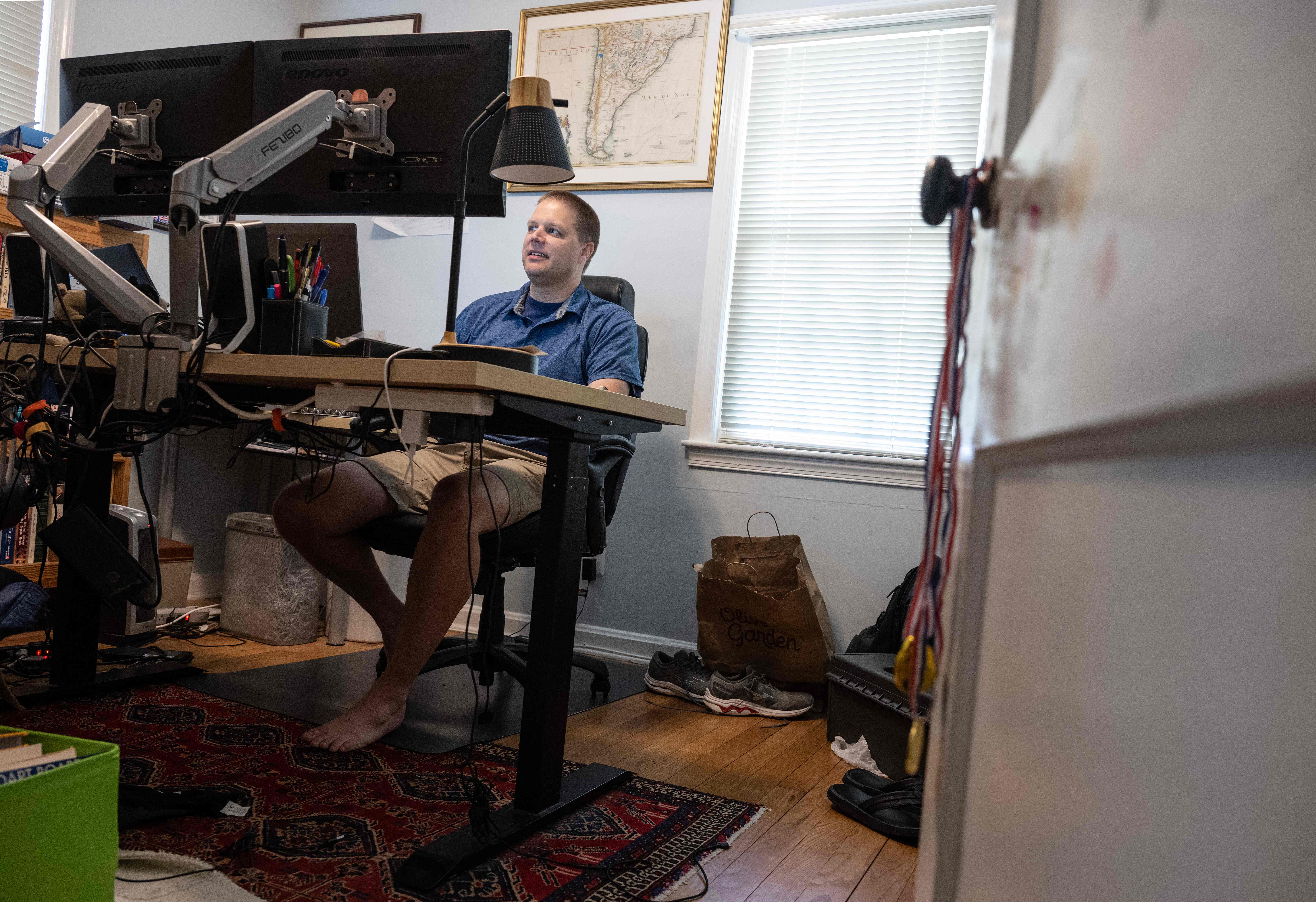 A man works from his home in Arlington, Virginia. Employers can help their employees by checking in with them once a week