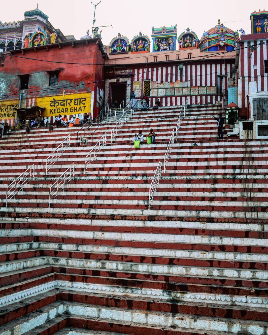 Kedar Ghat: Dedicated to Lord Shiva as Kedar, this ghat features a striking red-and-white striped temple reminiscent of the Himalayas. South Indian devotees especially throng here during Shivaratri to perform abhishek and ritual baths, creating a unique, cross-cultural atmosphere of deep devotion. Kedar Ghat: Dedicated to Lord Shiva as Kedar, this ghat features a striking red-and-white striped temple reminiscent of the Himalayas. South Indian devotees especially throng here during Shivaratri to perform abhishek and ritual baths, creating a unique, cross-cultural atmosphere of deep devotion.